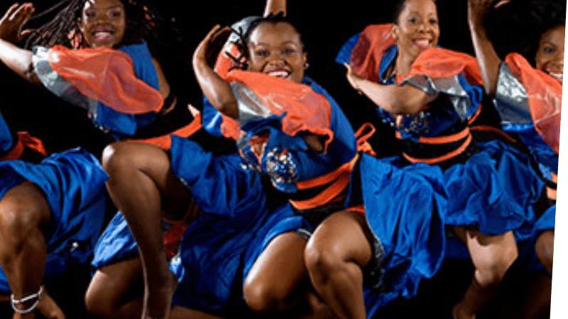 Dancers from the ASASE YAA Cultural Foundation dancing in blue and orange dress.