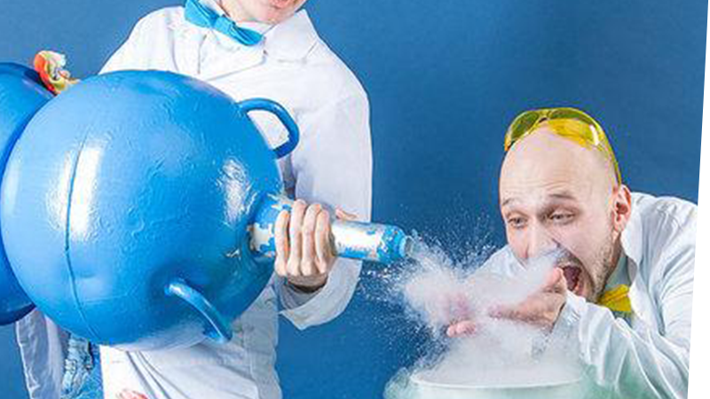 Two silly scientists working with a large container of liquid nitrogen
