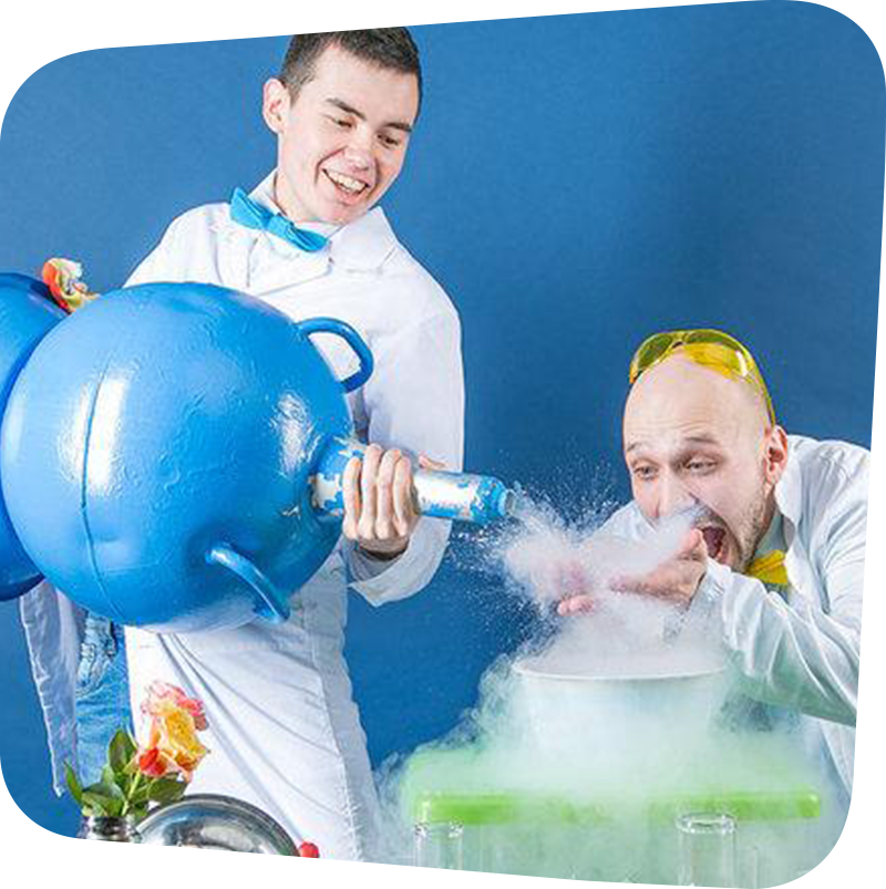 Two silly scientists working with a large container of liquid nitrogen