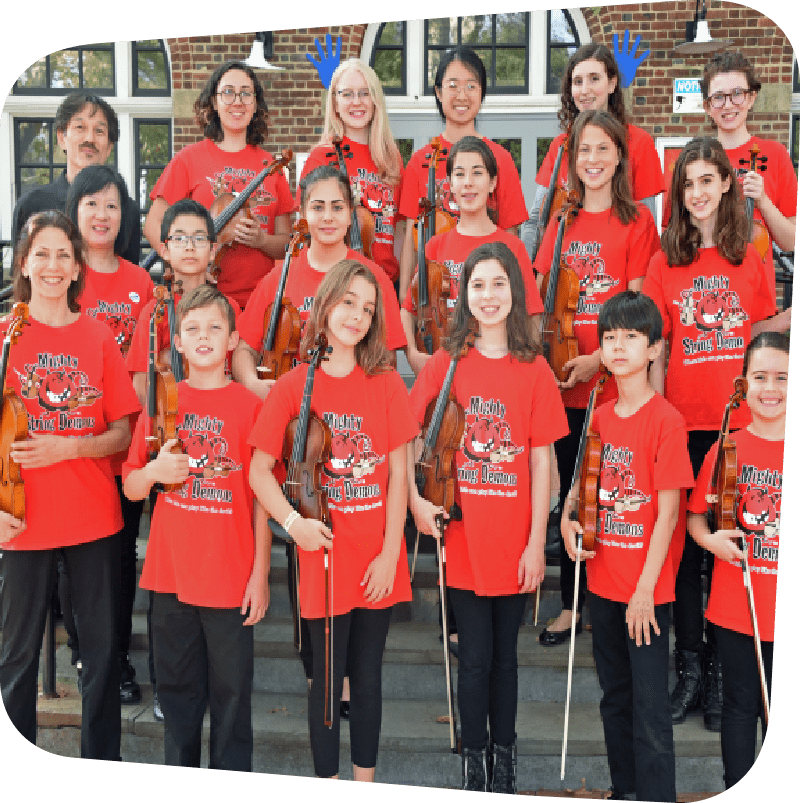 Depicts the Mighty String Demons youth violinist group. Children stand on the front steps of the Staten Island Children's Museum holding their violins. Standing with them are their director, Sanchie Bobrow holding a violin, and guest musicians Wenyi Lo and Kazuo Nakamura. All except Nakamura wear identical red Mighty String Demons shirts.