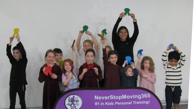 kids in the gallery holding up awards after never stop moving 365 event in gallery